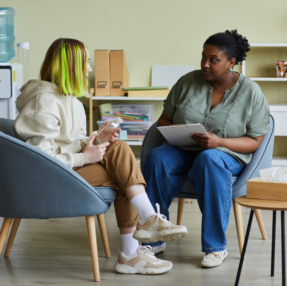 Two women talking in a room.